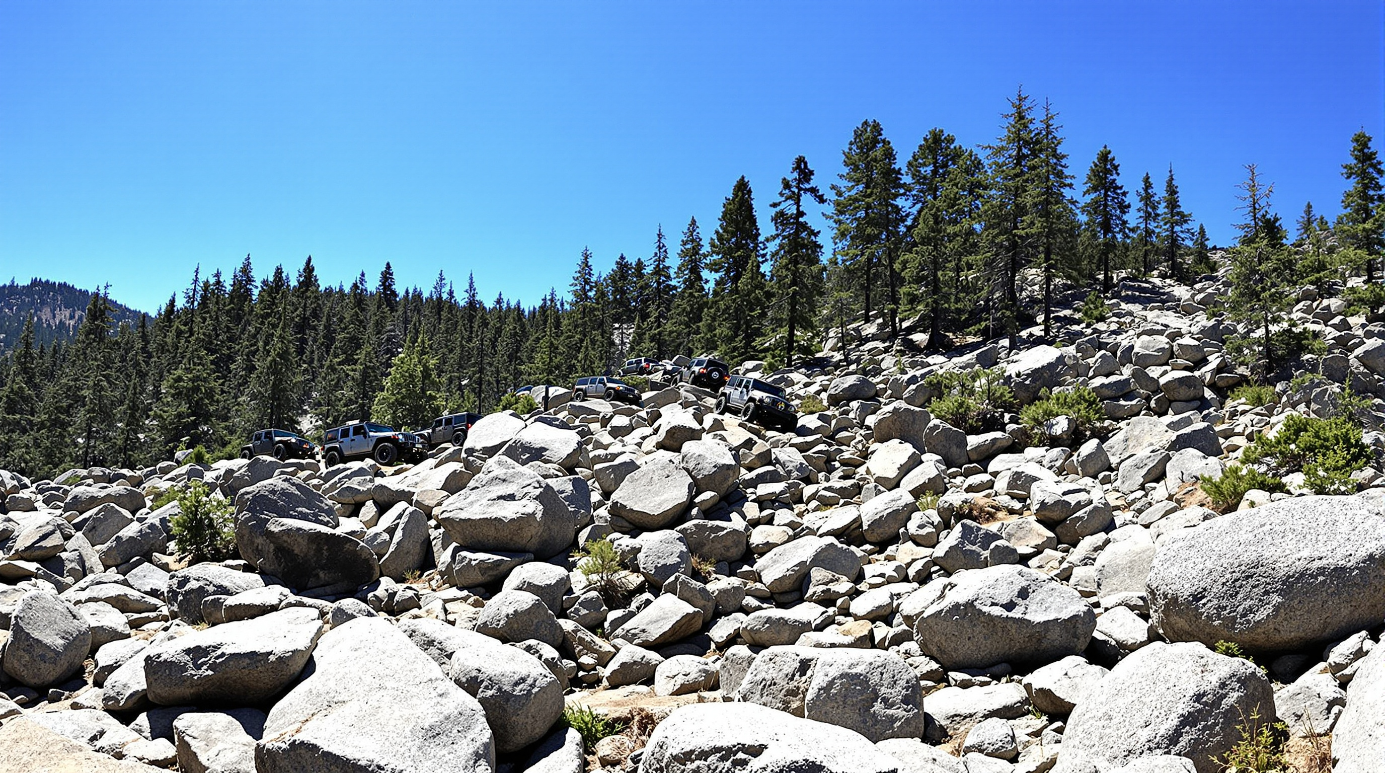 Jeeps navigating boulder obstacles on Rubicon Trail